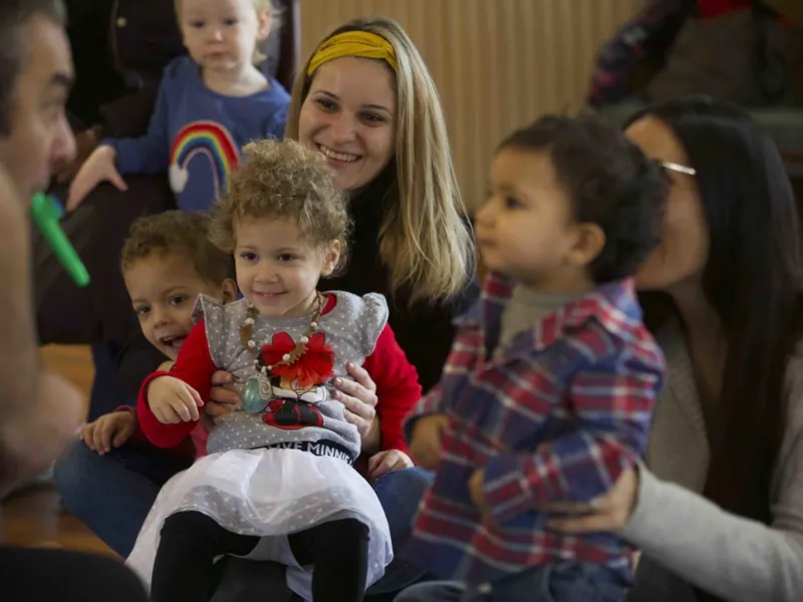 Grown-ups holding toddlers on their laps during a Rockness Music class