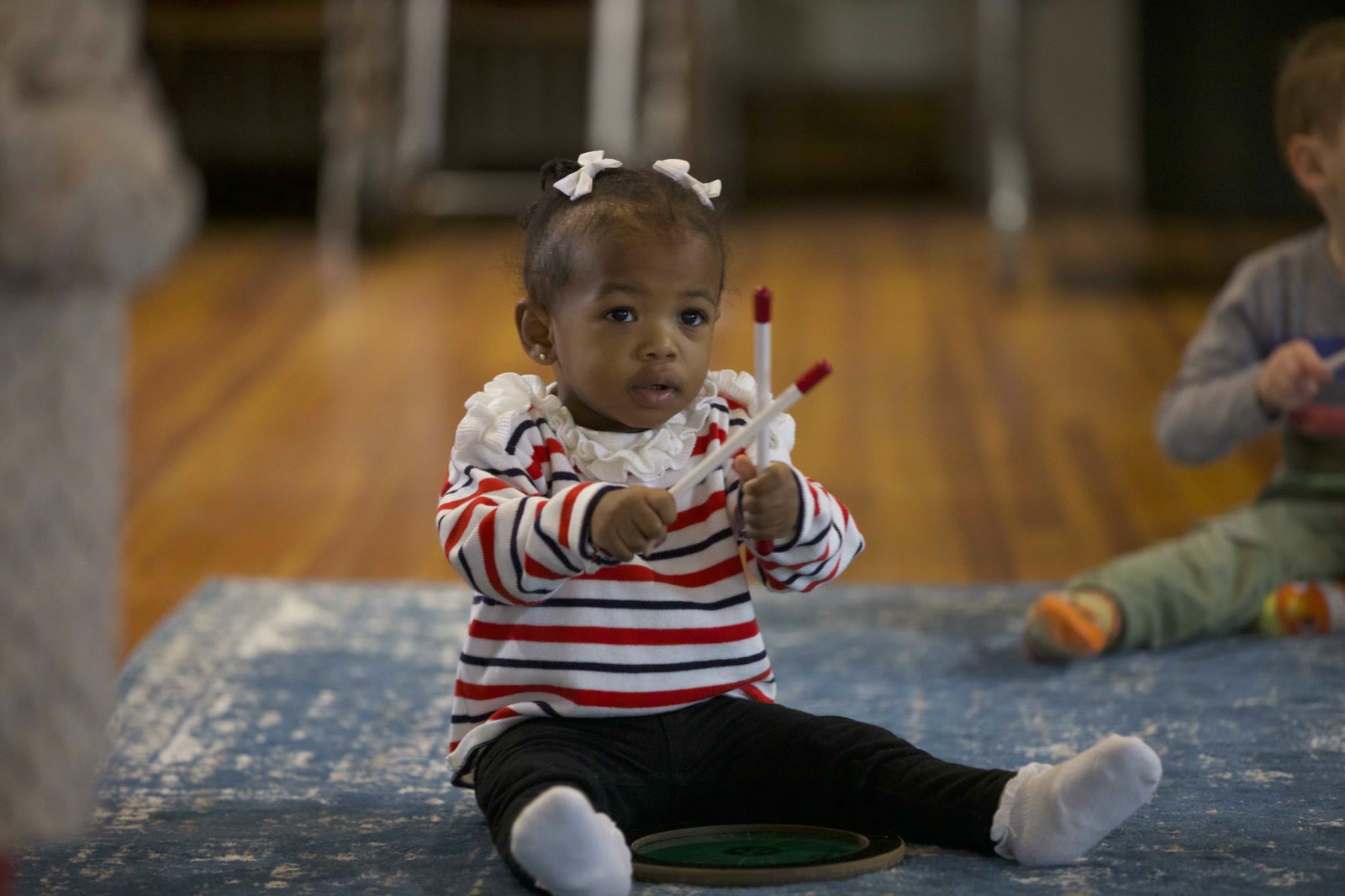 Toddler banging on pots and pans like a drum kit