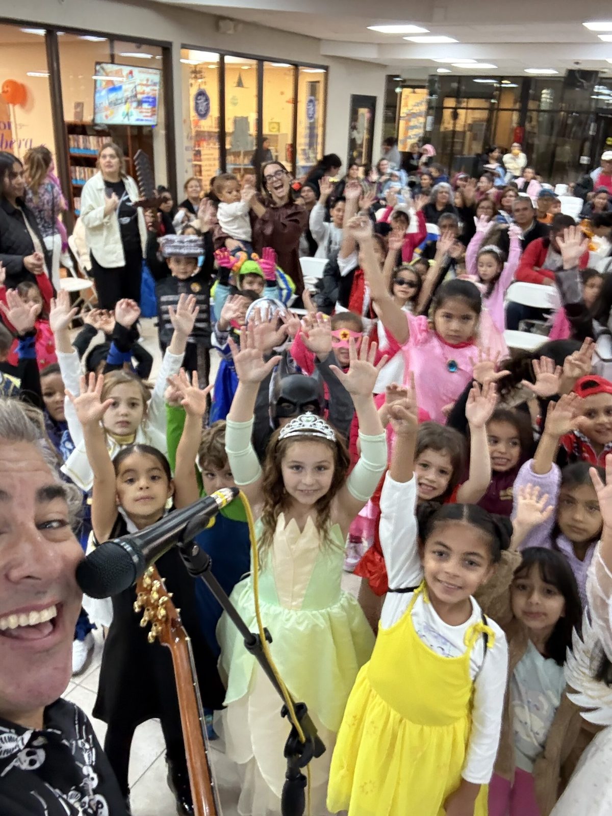 Kids and teachers with hands up during a Rockness school show