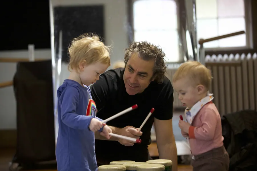 Mr. Michael playing drums with toddlers in class