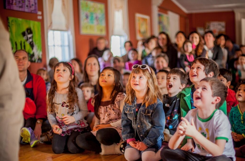 To show kids enjoying birthday party entertainment.