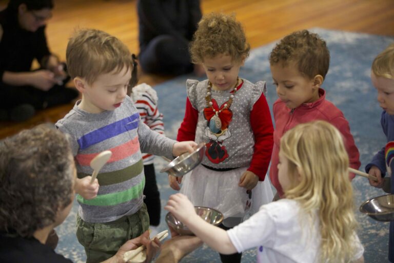 Showing kids cleaning up instruments in music class.