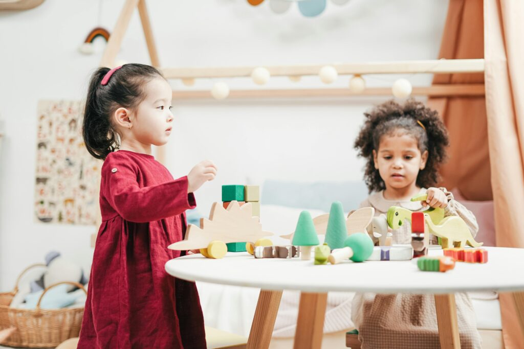 Happy preschool children staying active indoors in winter