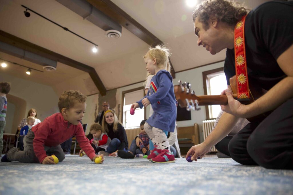 Children shaking musical shakers during a kids’ music class