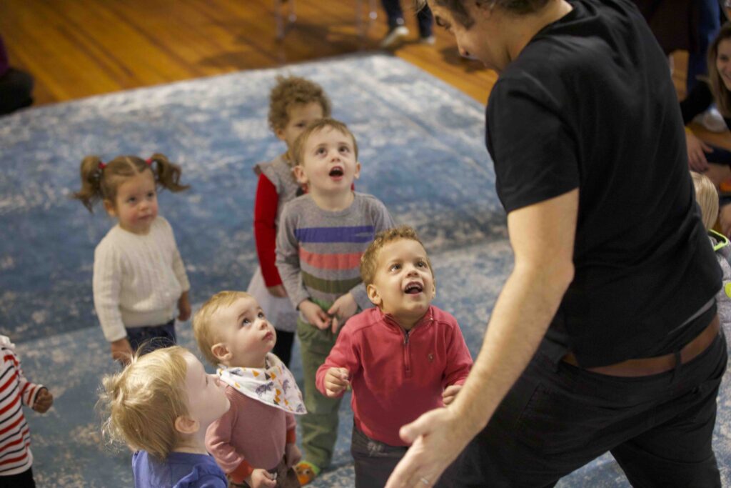 Children watching the music teacher with amazement during music class